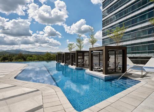 a swimming pool on the side of a building at Swissôtel Clark Philippines in Clark