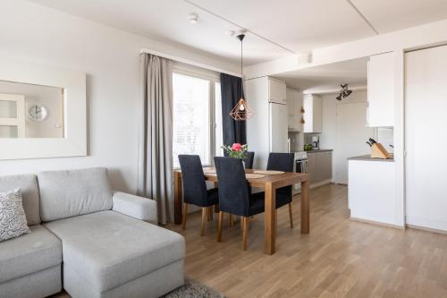 a living room and dining room with a table and chairs at Arctic Railway City Suite in Rovaniemi