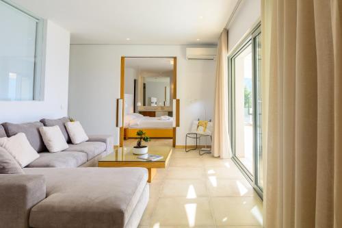 a living room with a couch and a mirror at Villa Thilia in Meganisi
