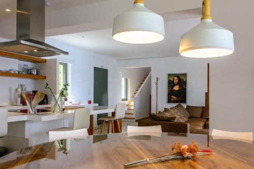 a kitchen and living room with a table and chairs at Villa Thilia in Meganisi