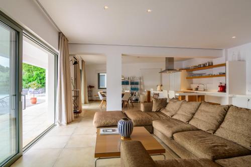 a living room with a couch and a table at Villa Thilia in Meganisi