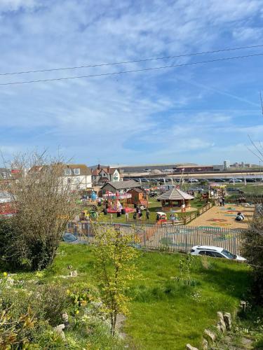 a town with a park with a train in the background at Pier Plain By The Sea in Gorleston-on-Sea