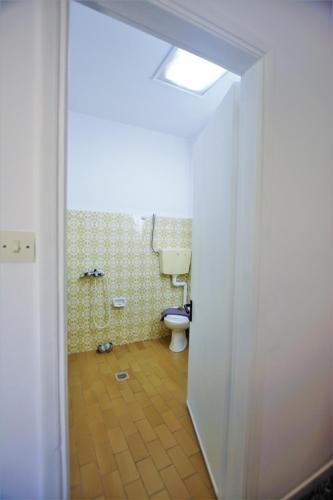 an open door to a bathroom with a toilet at Petros Giatras - Rooms in Zakynthos Town