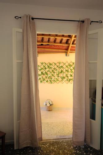 a door with a curtain in a room at Petros Giatras - Rooms in Zakynthos Town