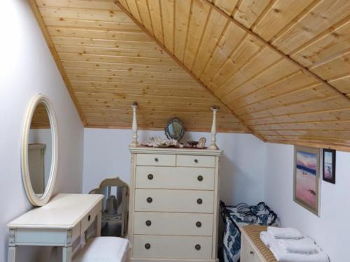 a bedroom with a dresser and a wooden ceiling at Verada Tour Guest House in Somova