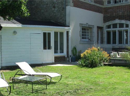 two chairs and a table in the yard of a house at La Demeure de Laclais in Le Mans