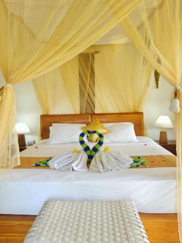 Säng eller sängar i ett rum på Uma Agung Villa