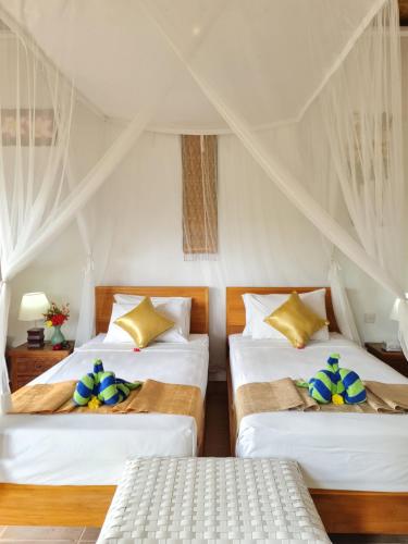 Ένα ή περισσότερα κρεβάτια σε δωμάτιο στο Uma Agung Villa