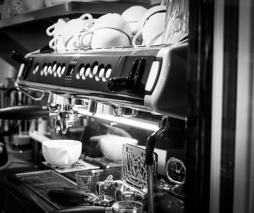 a kitchen counter with plates and bowls on a shelf at Conon Hotel in Dingwall