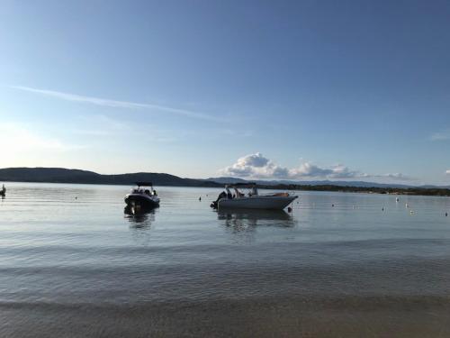 two boats sitting in the water on a lake at Makis Nest Apart-Hotel in Vourvourou