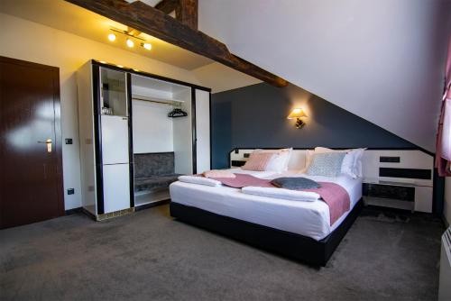 a bedroom with a large bed in a room at La Conacul Vesel Săpânța in Săpînţa