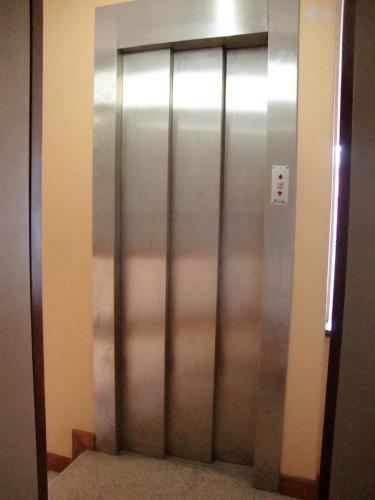 a metal elevator door in a building at Casa de Retiros N. S. Perpetuo Socorro in Guimarães