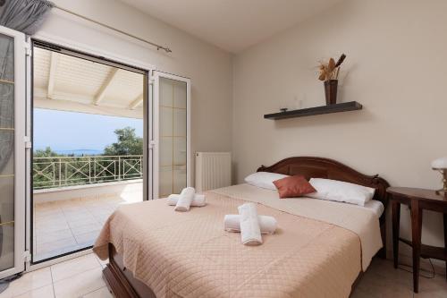 a bedroom with a bed with towels on it at Villa Mythos with Infinity Pool in Dassia