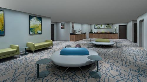 a lobby with a couch and a table and chairs at Ibis Jeddah Malik Road in Jeddah