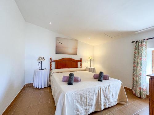 a bedroom with a bed and a table at Finca Son Rengo in Campos
