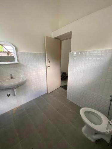 a bathroom with a toilet and a sink at Habitat15@airlines in Bangalore