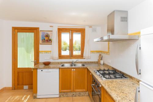 a kitchen with a sink and a stove at Finca Son Rengo in Campos
