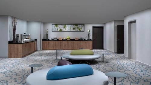a lobby of a hotel with a table and chairs at Ibis Jeddah Malik Road in Jeddah