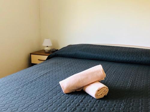 a towel laying on a bed in a room at Apartmani Lovre Posedarje in Posedarje