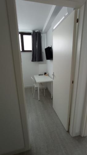 a white room with a table and a window at Rosa's Rooms in Matera