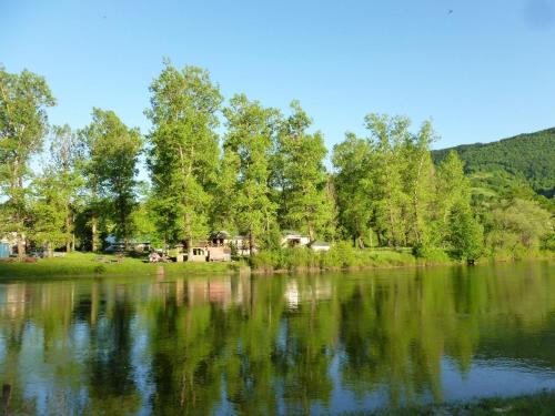 a view of a lake with trees in the background at Bed and Breakfast Family Djukic in Šipovo