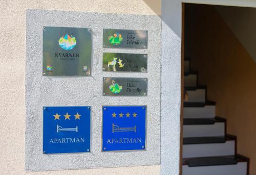 a wall with signs on the side of a building at Apartmani Sabina in Fužine