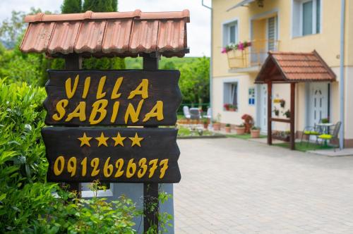 a sign for a villa sailia in front of a house at Apartmani Sabina in Fužine