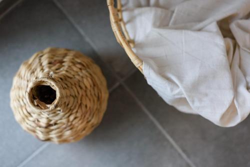 a wicker basket sitting on a floor next to a napkin at Bleu clair luxury living in Argostoli