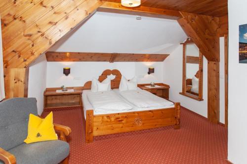 a bedroom with a bed in a room with wooden ceilings at Gästehaus Sonnenheim in Mittenwald