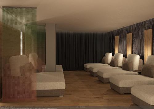 a waiting room with a row of white chairs at Hotel Al Cervo in Tesero