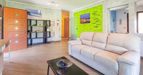una sala de estar con un sofá y una mesa en Albarosa, en Fertilia