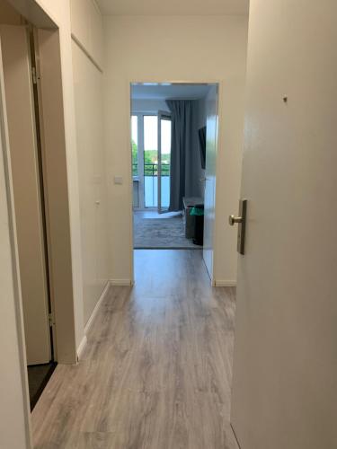 an empty room with a hallway with wood floors at Wohlfühlwohnung in Halstenbek in Halstenbek