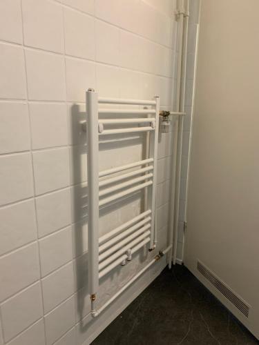 a bathroom with a white radiator on the wall at Wohlfühlwohnung in Halstenbek in Halstenbek