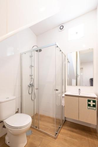 a bathroom with a shower and a toilet and a sink at Downtown A whole house duplex designed for remote work and near metro lapa in Porto