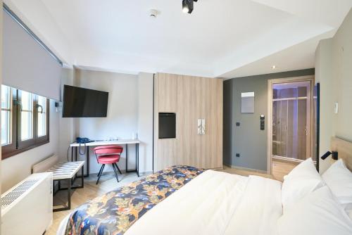 a hotel room with a bed and a desk at The Mavili urban stay in Thessaloniki