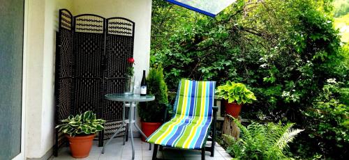 a patio with a table and two chairs and plants at Casa Servatius in Briedel