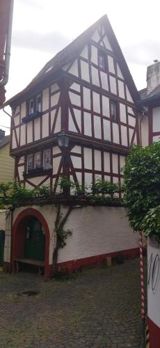 a half timbered house with an archway in front of it at Casa Servatius in Briedel