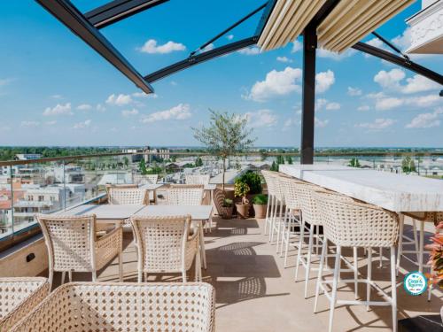 a balcony with tables and chairs and a view of the city at Prezident Palace Belgrade - Adults Only in Belgrade