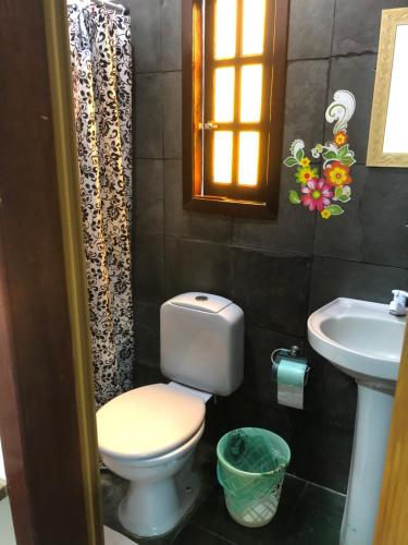 a bathroom with a toilet and a sink at Flat Maricá II in Maricá