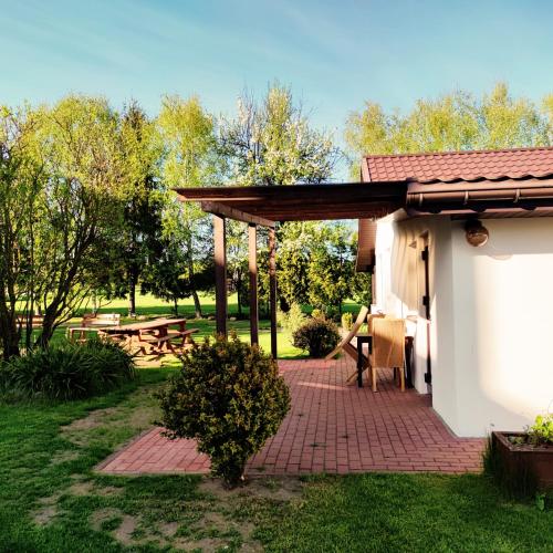 a patio with a pavilion and a picnic table at Biebrza24 - Agroturystyka in Sztabin