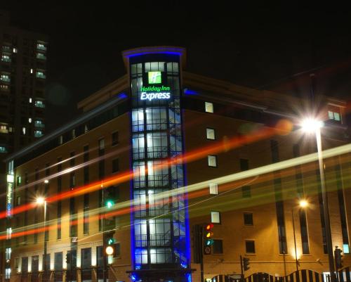 a large building with a clock on the side of it at Holiday Inn Express London Stratford, an IHG Hotel in London