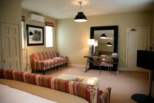 a living room with a couch and a table at Milsoms Kesgrave Hall in Ipswich