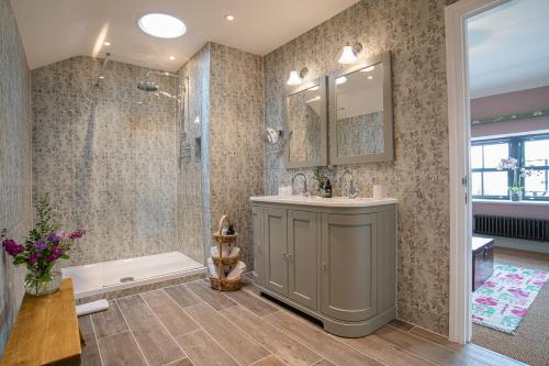 a bathroom with a shower and a sink and a tub at The White Lion Cowbridge in Cowbridge