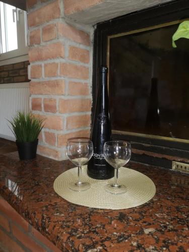 a bottle of wine and two glasses on a counter at Makis Nest Apart-Hotel in Vourvourou