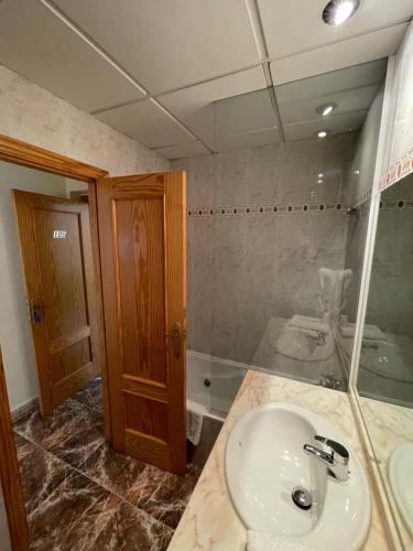 a bathroom with a sink and a shower at Hostal Rosaleda in Alcalà de Xivert