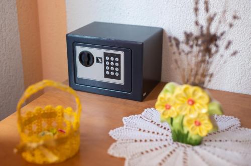 a small alarm clock and a basket on a table at Apartmani Sabina in Fužine