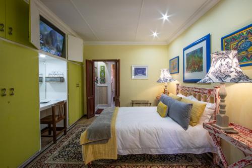 a bedroom with a large bed and a desk at The Tuscan Garden in Newcastle