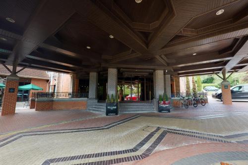 a building with a lobby with bikes parked in front of it at Village Hotel Swindon in Swindon