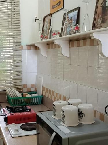 a kitchen with a counter with dishes on it at Port Dickson Seaview Homestay in Port Dickson