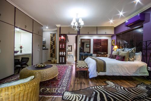 a hotel room with a bed and a zebra rug at The Tuscan Garden in Newcastle